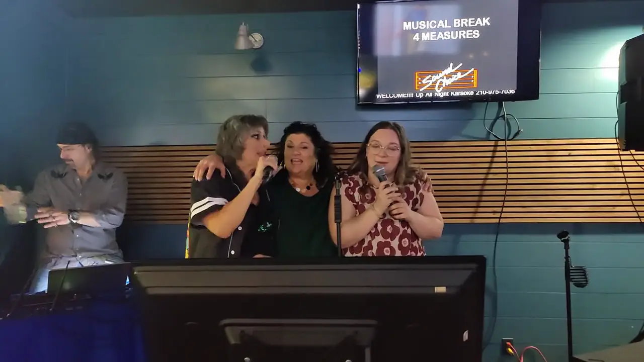 Three friends singing karaoke at Lefty's Draft House